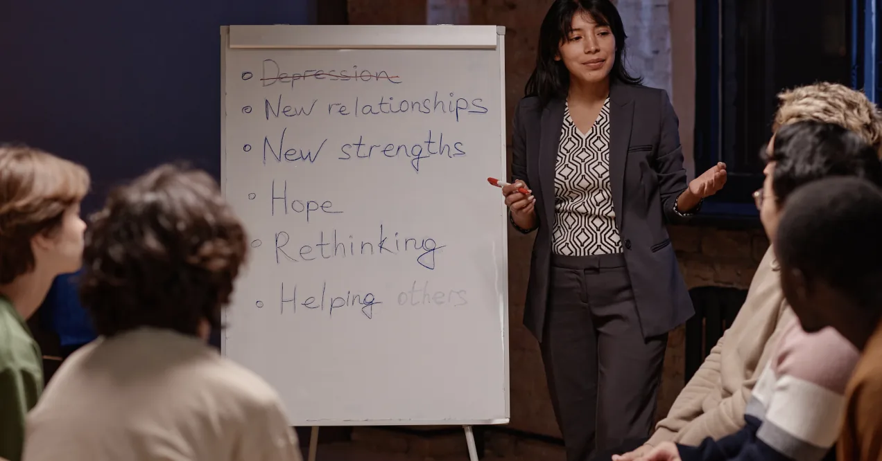person speaking to a group using a chart