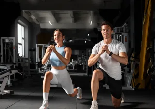 woman helping man gym